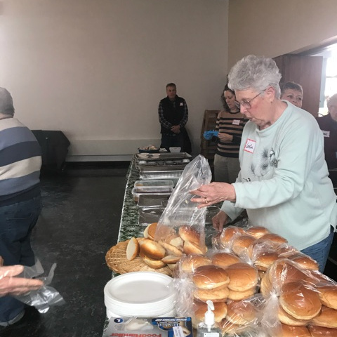 church member serving food at warming shelter